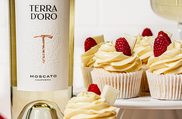 bottle of Terra d'Oro moscato and white chocolate raspberry cupcakes